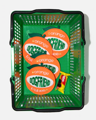 Orange dog flying discs in a green basket