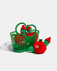 Apple plush dog toys with green worms in and beside a green basket