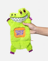 Hand holding a green crocodile plush dog toy