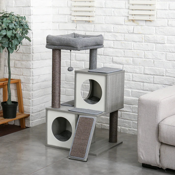 Grey wooden cat tree with top bed in a living room