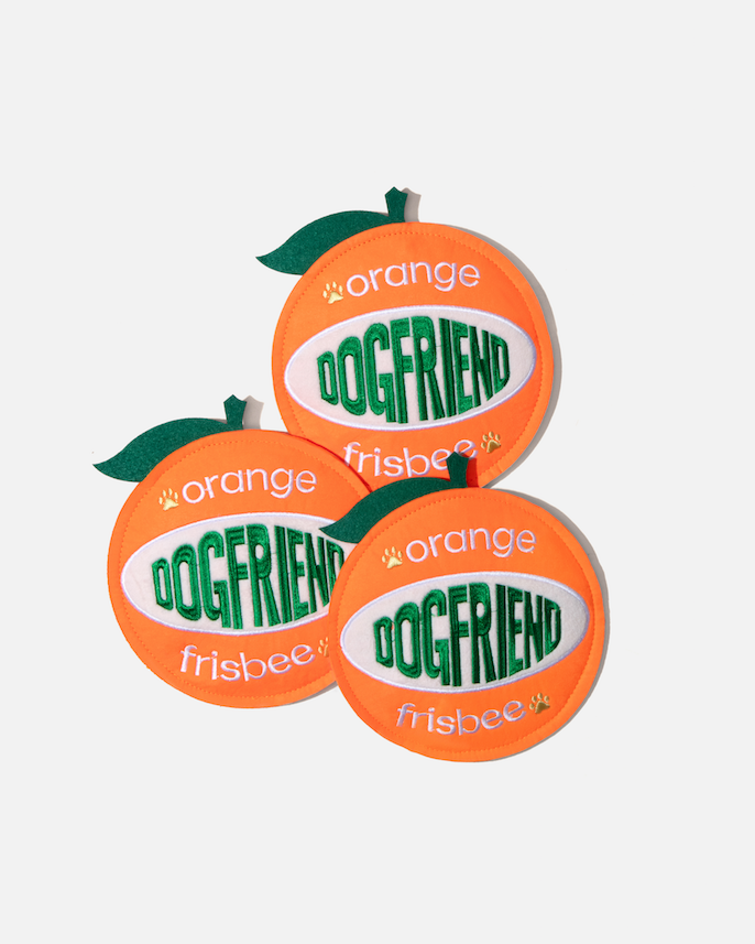 Three orange-shaped dog flying discs