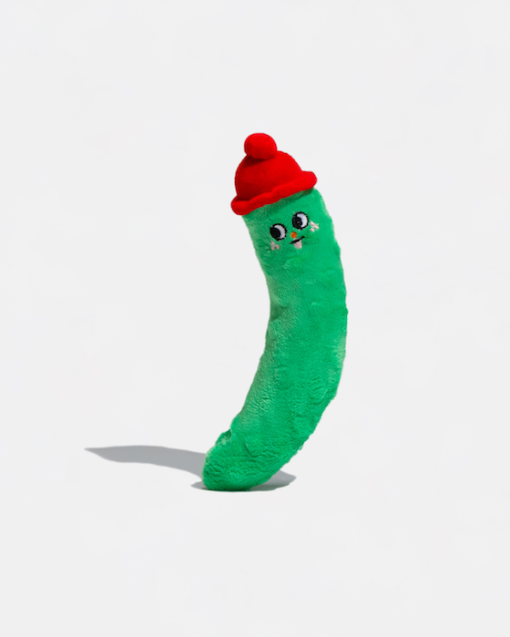 Green worm plush toy wearing a red hat