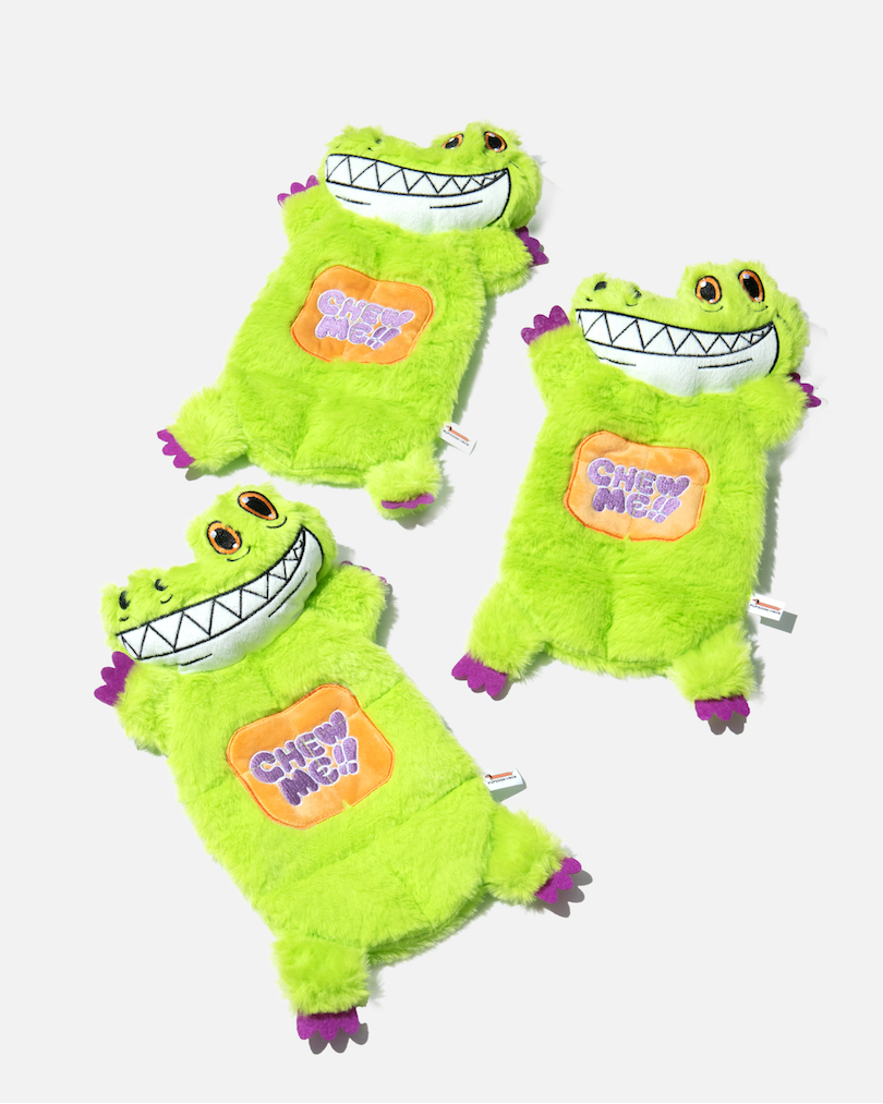 Three green crocodile plush dog toys arranged together